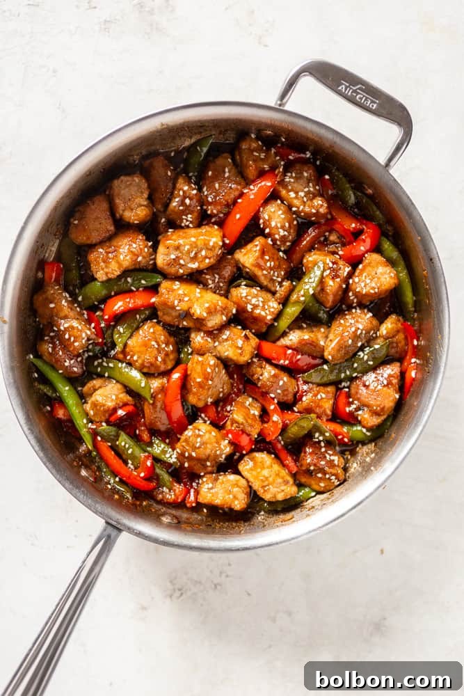 Sweet and Sticky Honey Garlic Pork Stir Fry 8 Honey garlic pork stir fry in a stainless steel saute pan.