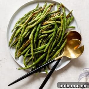 Beautifully roasted green beans, ready to serve, presented in a dish with a rustic charm.