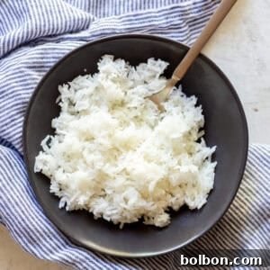 Master the Art of Fluffy White Rice 6 Close-up of fluffy white rice in a saucepan, ready to be served.