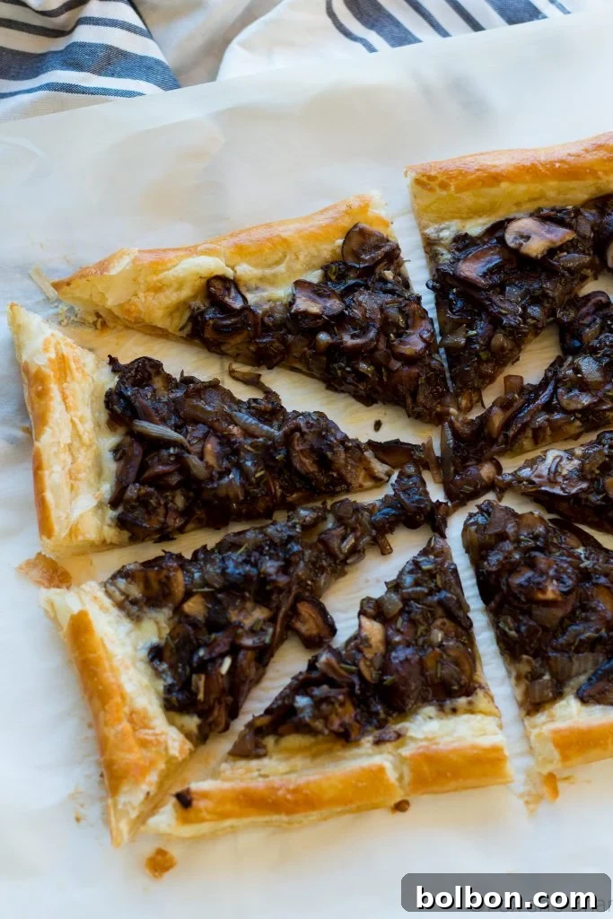 A final close-up of the savory mushroom and gruyere tart, highlighting its delicious crust and rich filling.