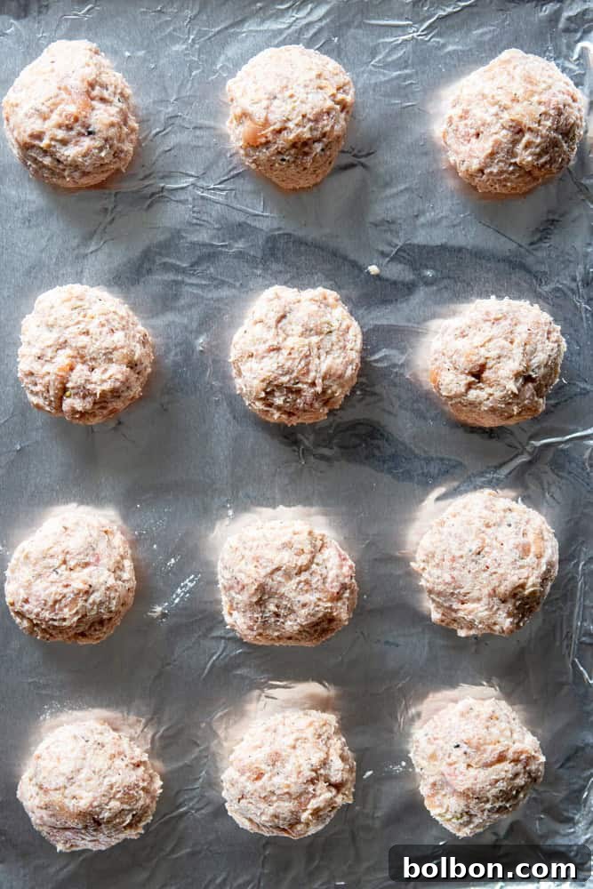 Turkey Ricotta Meatballs arranged neatly on a baking sheet, ready for baking in the oven.