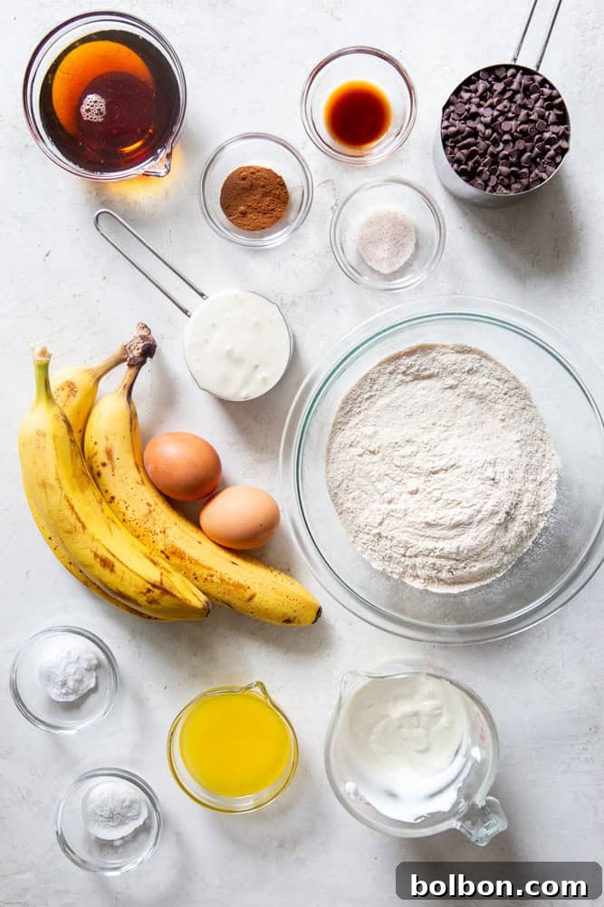 Wholesome Sourdough Banana Muffins 3 Ingredients for healthy sourdough banana muffins neatly arranged on a counter: maple syrup, cinnamon, vanilla extract, sea salt, mini chocolate chips, ripe bananas, eggs, white whole wheat flour, sourdough discard, Greek yogurt, butter, baking powder, baking soda