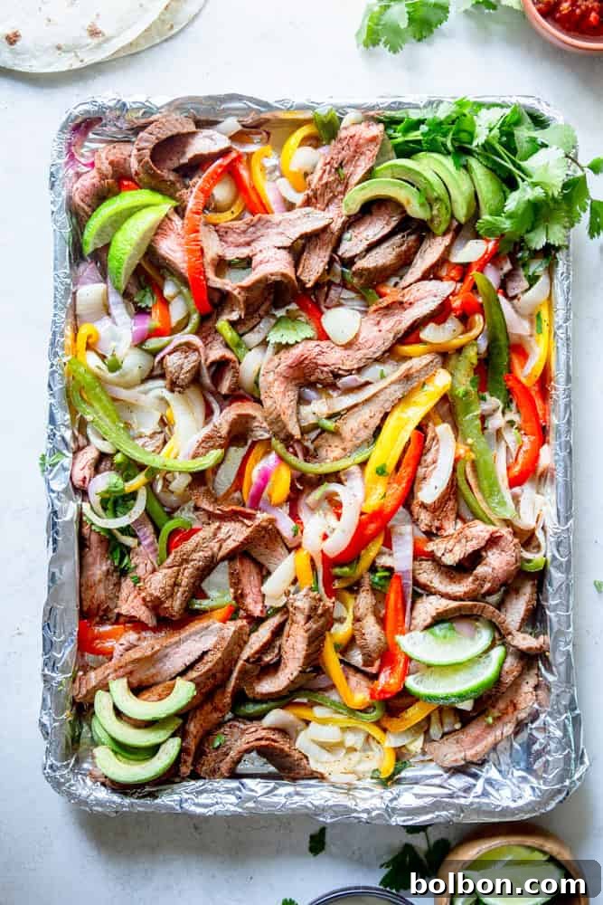 Sheet Pan Steak Fajita Feast 2 Sheet Pan Steak Fajitas on a foil lined sheet pan, beautifully cooked and ready to serve.