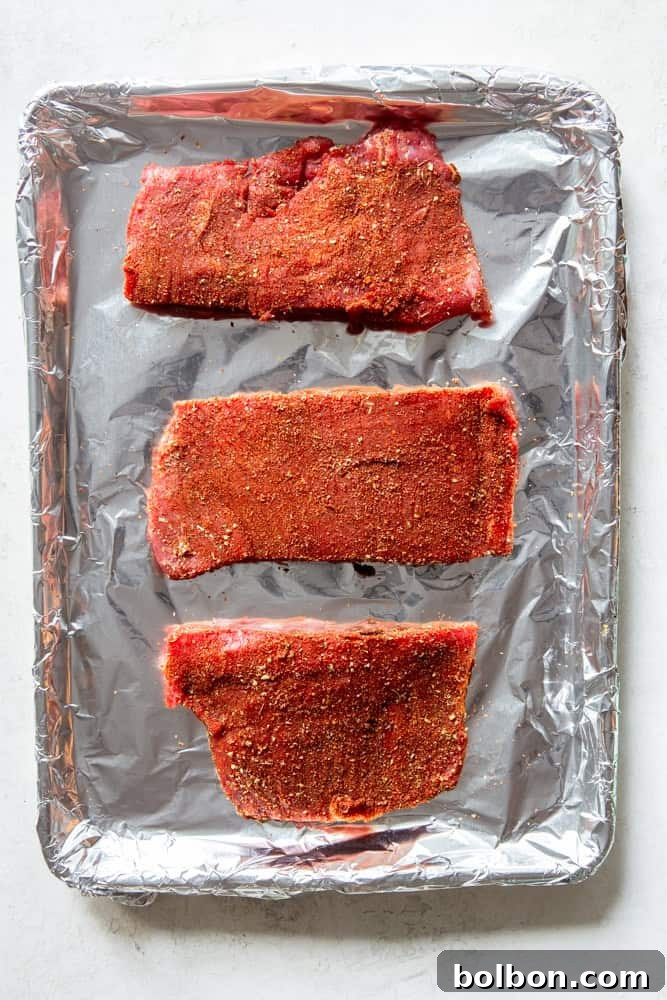 Sheet Pan Steak Fajita Feast 4 Uncooked flank steak, neatly trimmed and ready for seasoning, showcasing its lean texture.