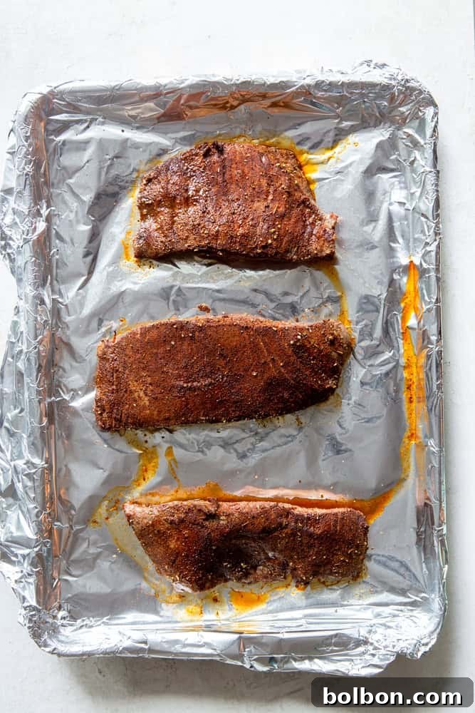 Sheet Pan Steak Fajita Feast 5 Perfectly cooked flank steak, browned on the outside and tender within, resting after being removed from the oven.