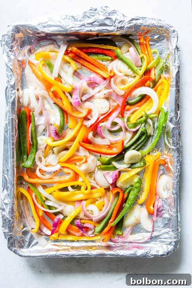 Sheet Pan Steak Fajita Feast 7 Roasted onions and bell peppers, tender with slightly charred edges, after being cooked on a sheet pan.