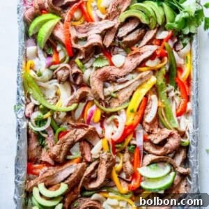 A vibrant close-up of the cooked Sheet Pan Steak Fajitas, with perfectly seared steak and colorful, tender vegetables.