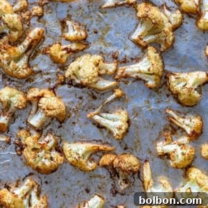 A close-up of beautifully roasted cauliflower florets with golden-brown edges, served in a bowl.