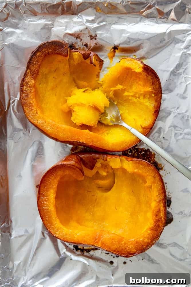 A perfectly roasted pie pumpkin, cut in half, its caramelized edges hinting at the sweet puree to come.