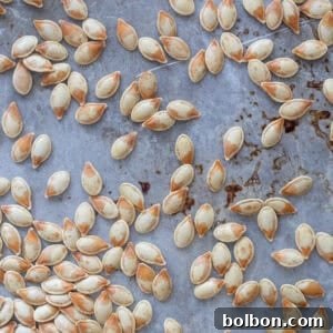 Crispy Roasted Pumpkin Seeds 7 Crispy, perfectly golden roasted pumpkin seeds in a rustic bowl, ready to be devoured.