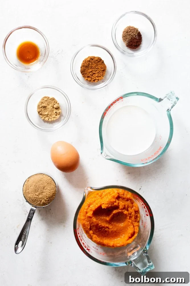 Petite Pumpkin Tarts 3 Ingredients for pumpkin pie - pumpkin puree, brown sugar, egg, half and half, spices, vanilla, salt laid out on a table.