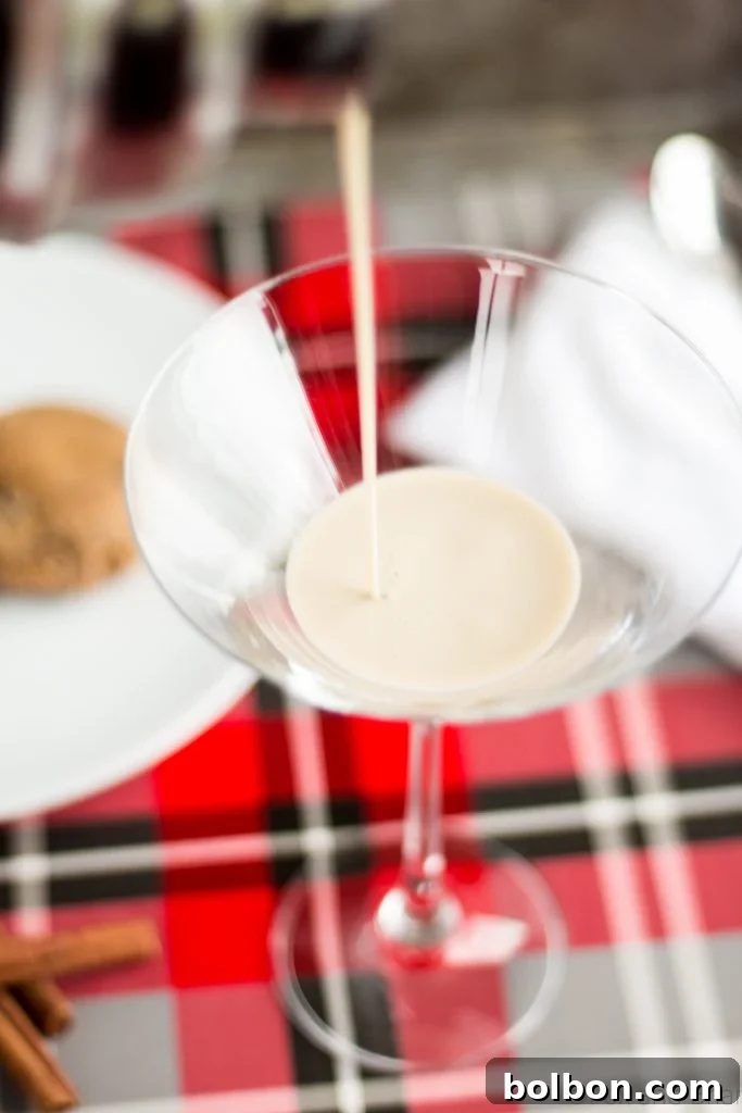 Gingerbread Martini Melodies 4 Close-up of a Gingerbread Martini with a subtle, warm holiday glow, emphasizing its appealing color and texture.