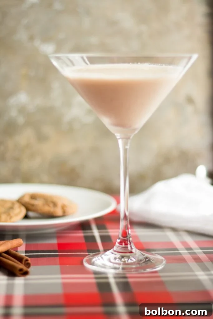 Gingerbread Martini Melodies 5 Overhead shot of a Gingerbread Martini surrounded by holiday decorations, highlighting its festive presentation.