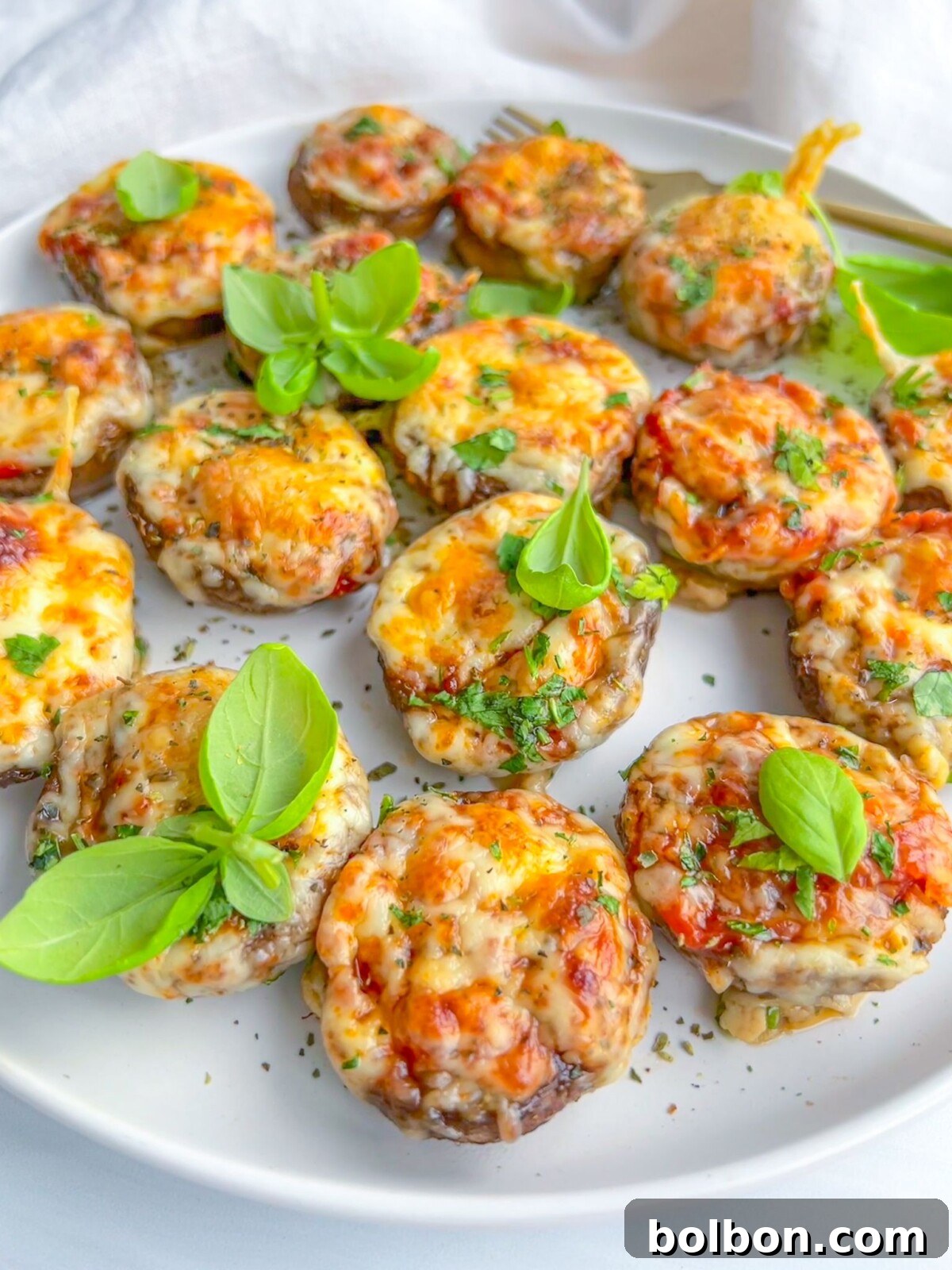 Close-up of freshly baked Pizza Stuffed Mushrooms with melted cheese and herbs, ready to be served.