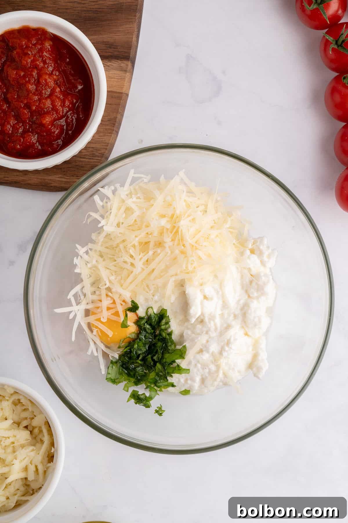 Picture of a bowl with the ricotta, egg, and parmesan in it. 