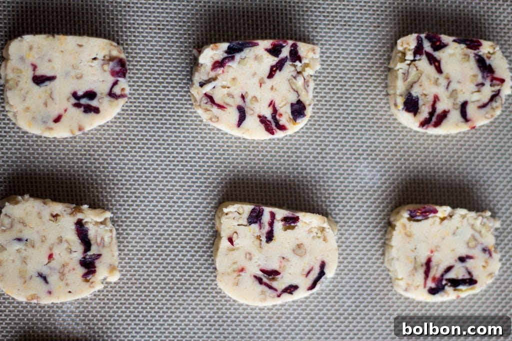 Cranberry Orange and Pecan Shortbread cookies. These easy, slice and bake cookies are flavored with orange zest, vanilla, cranberries and pecans. They are the perfect holiday cookies to give away or keep for yourself!