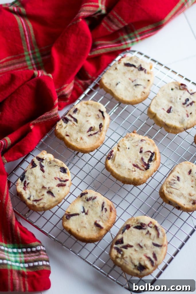 Cranberry Orange and Pecan Shortbread cookies. These easy, slice and bake cookies are flavored with orange zest, vanilla, cranberries and pecans. They are the perfect holiday cookies to give away or keep for yourself!