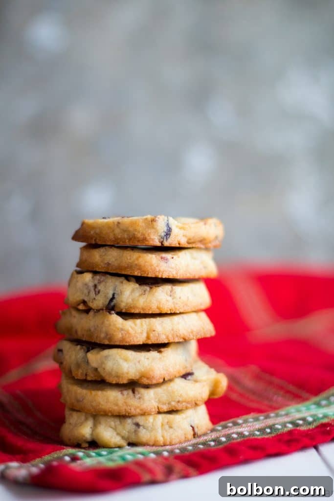 Cranberry Orange and Pecan Shortbread cookies. These easy, slice and bake cookies are flavored with orange zest, vanilla, cranberries and pecans. They are the perfect holiday cookies to give away or keep for yourself!