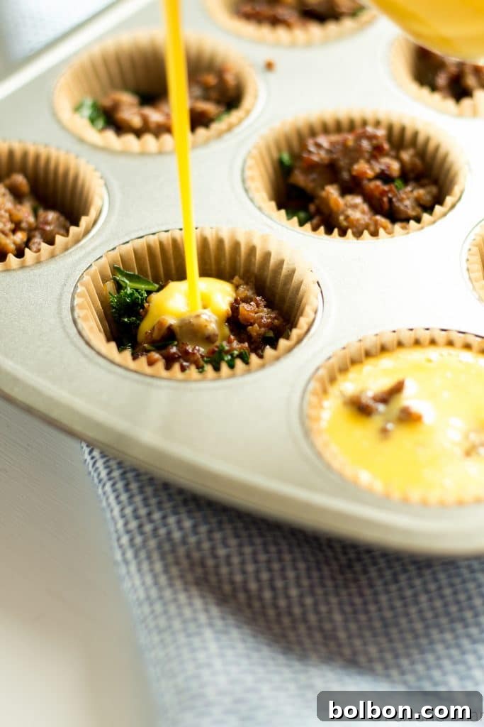 A tray of fresh baked sausage and kale egg muffins cooling on a wire rack