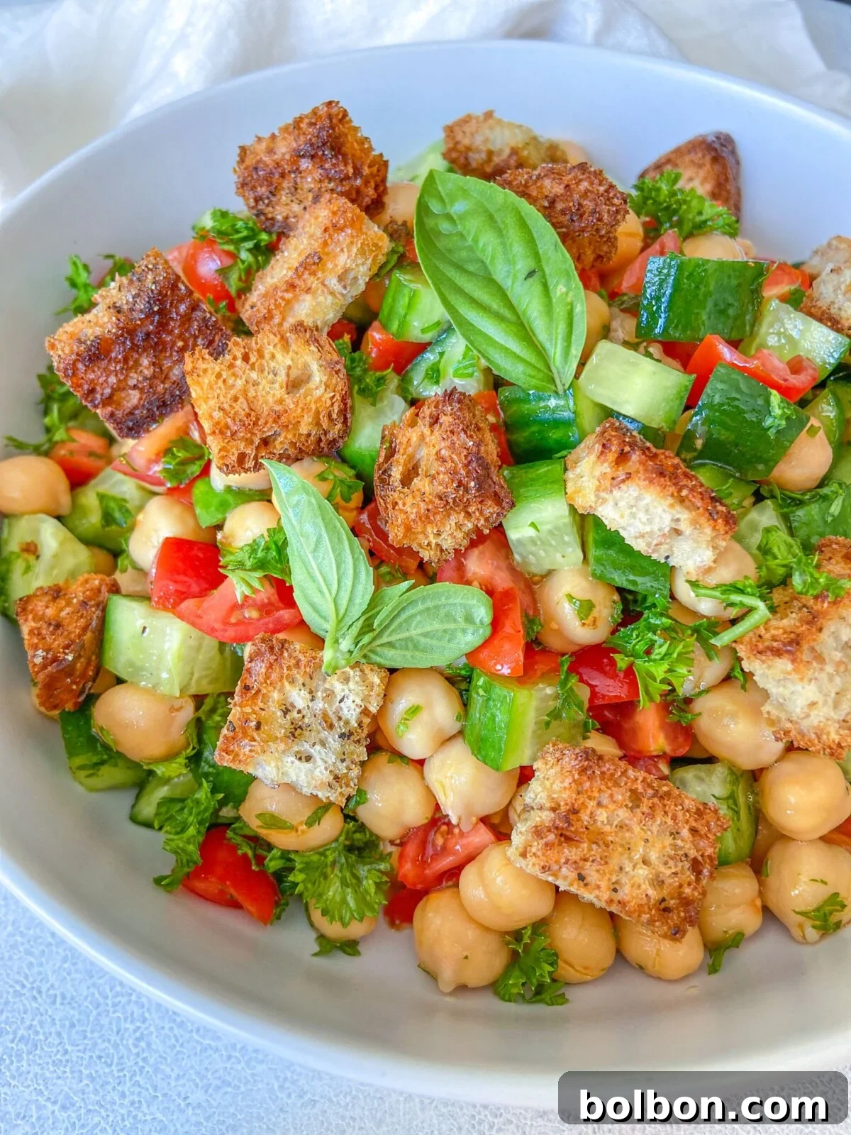 Chickpea Crouton Salad, a vibrant dish with crunchy bread, fresh tomatoes, and chickpeas.