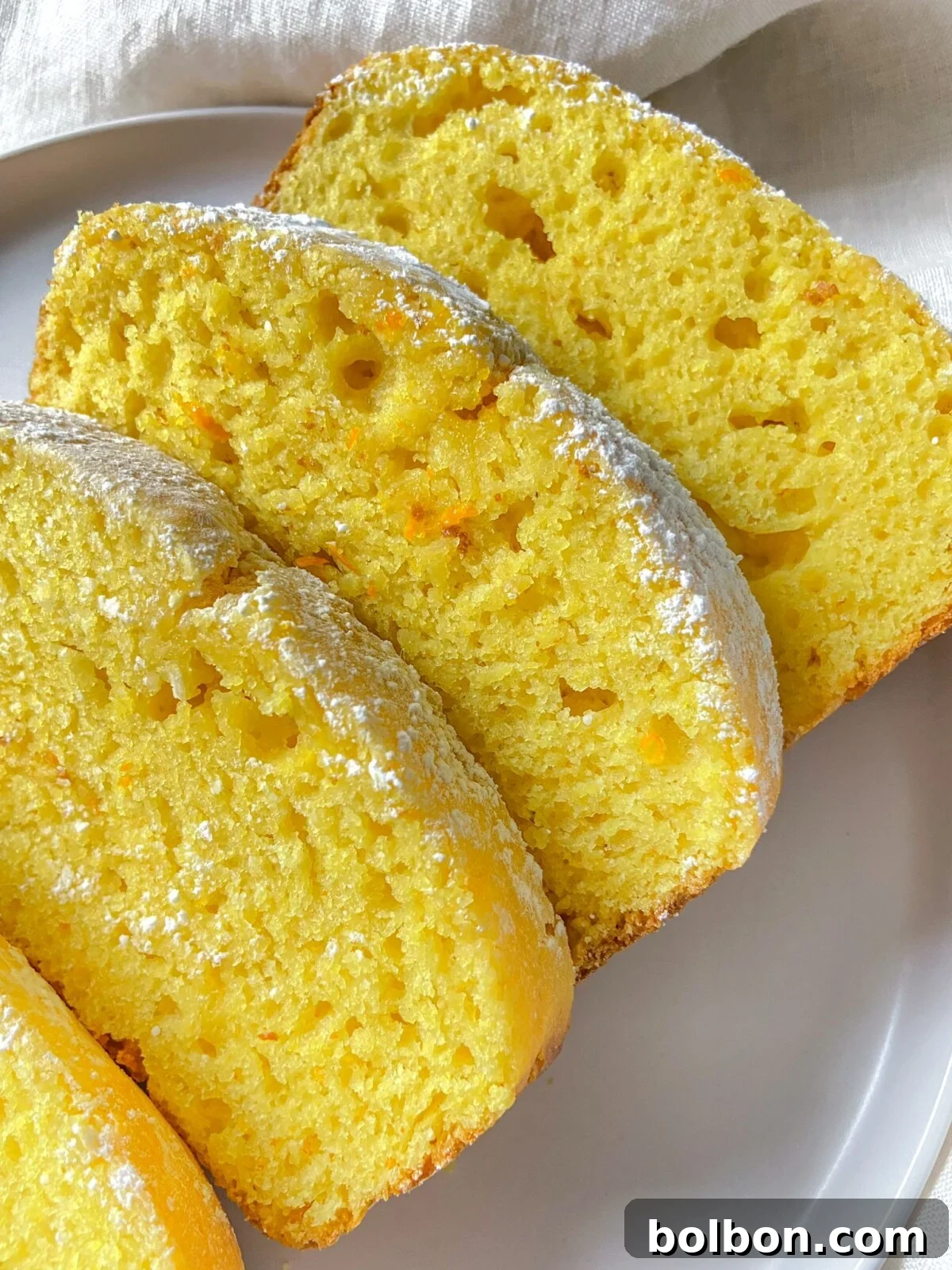 Zesty Orange Lemon Delight 2 A beautifully moist Orange Lemon Cake, sliced and ready to be served. The golden crust hints at its perfectly baked texture.