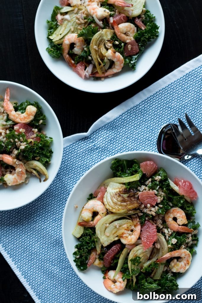 Close-up of roasted shrimp and fennel in a vibrant kale salad.