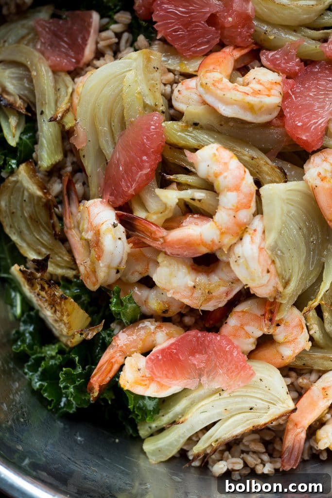A vibrant, finished Roasted Shrimp, Fennel, and Grapefruit Kale Salad ready to be served.