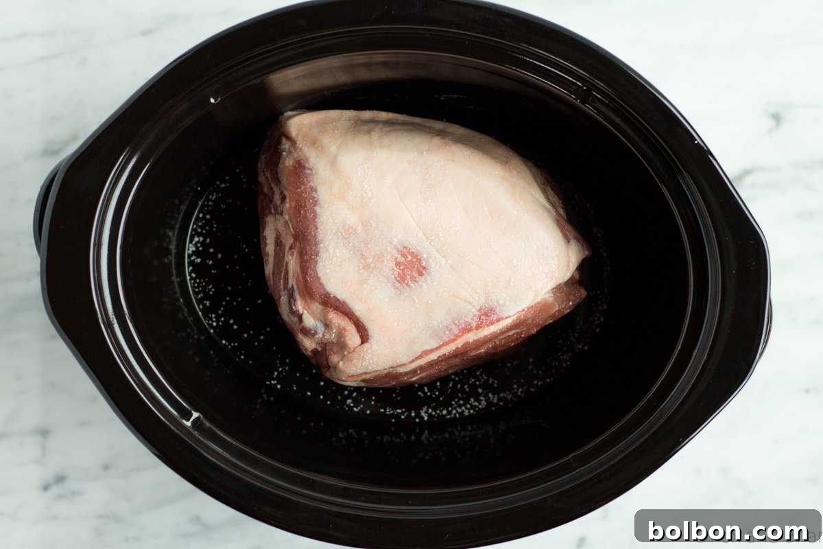 Hands-Off Slow Cooker Pulled Pork 3 Close-up of succulent pulled pork in a slow cooker
