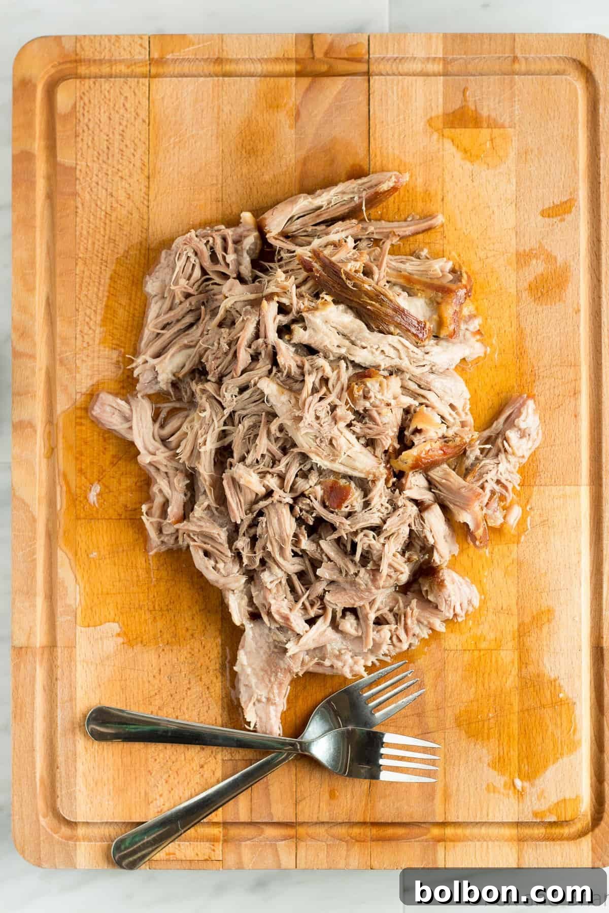 Hands-Off Slow Cooker Pulled Pork 6 Close-up of tender pulled pork in a bowl