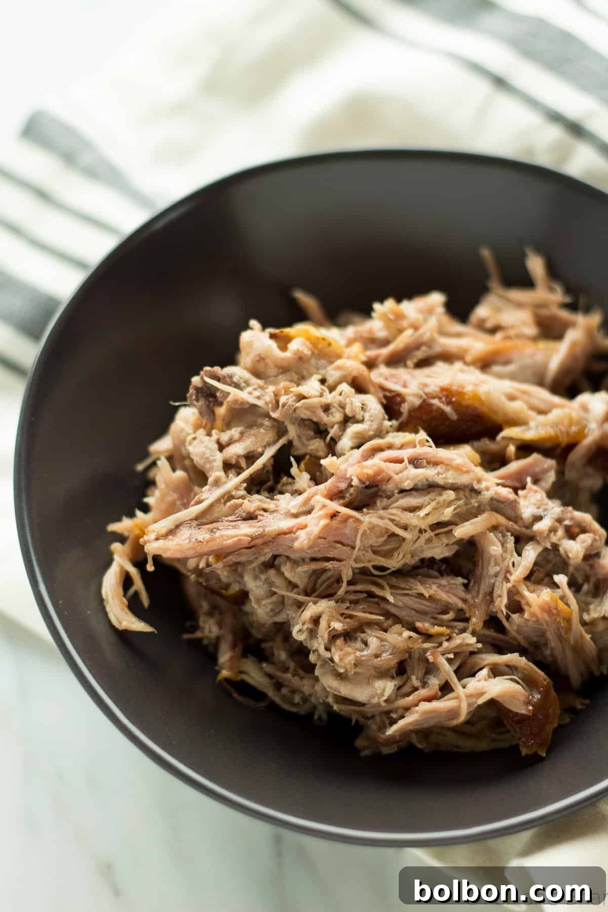Hands-Off Slow Cooker Pulled Pork 9 A bowl of delicious, shredded slow cooker pulled pork