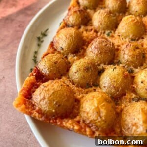 A close-up of Crispy Parmesan Potatoes with a golden-brown crust, ready to be served.