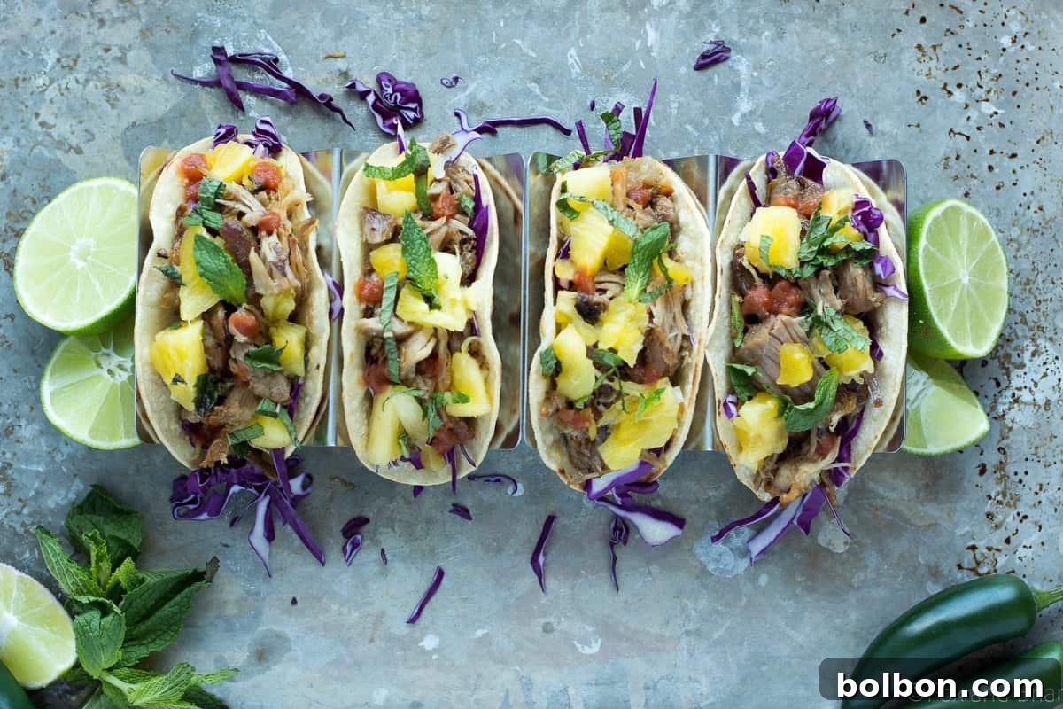 Delicious slow cooker pork tacos with pineapple mint salsa, ready to be served.