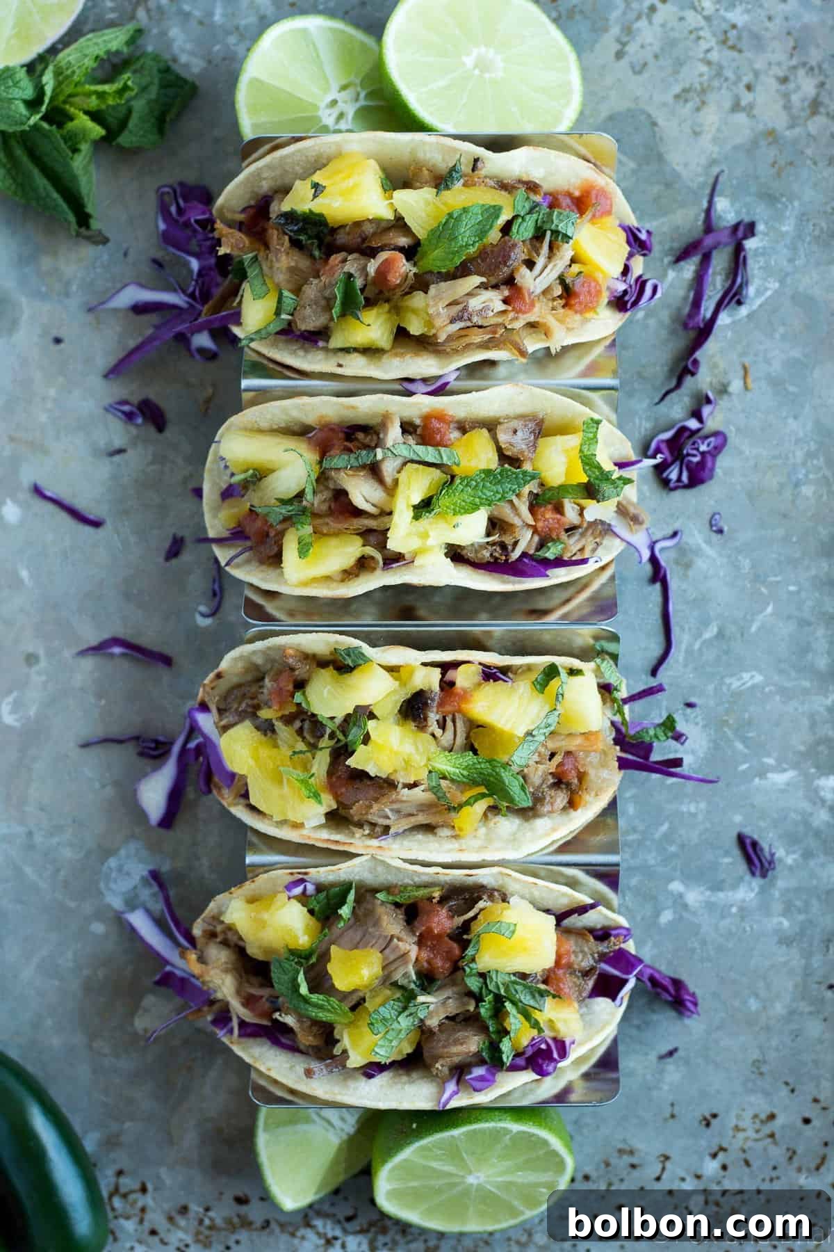 Close-up of a loaded slow cooker pork taco, showcasing tender pork, salsa, and cabbage.
