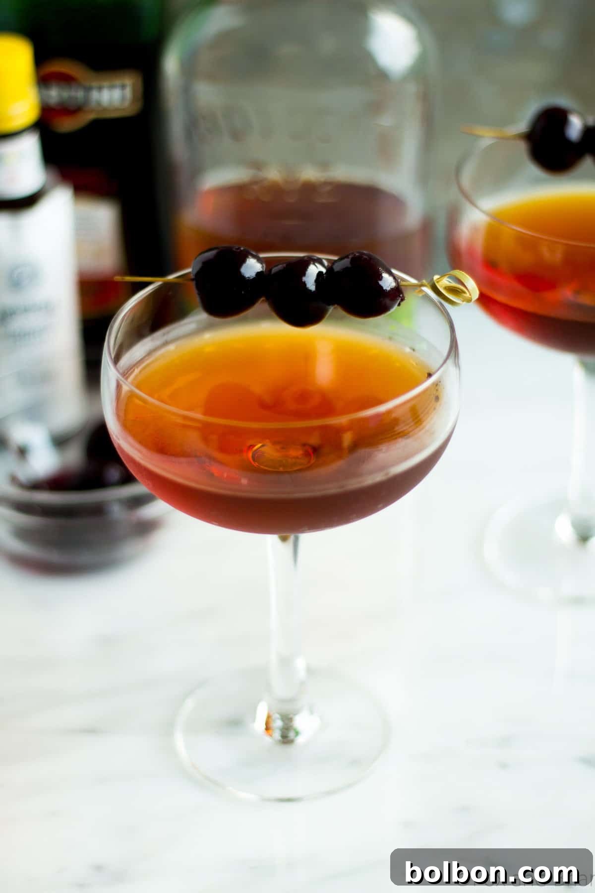 Crafting the Timeless Manhattan 5 A pristine Classic Manhattan served in a chilled coupe glass, elegantly garnished with a single, dark Luxardo cherry.