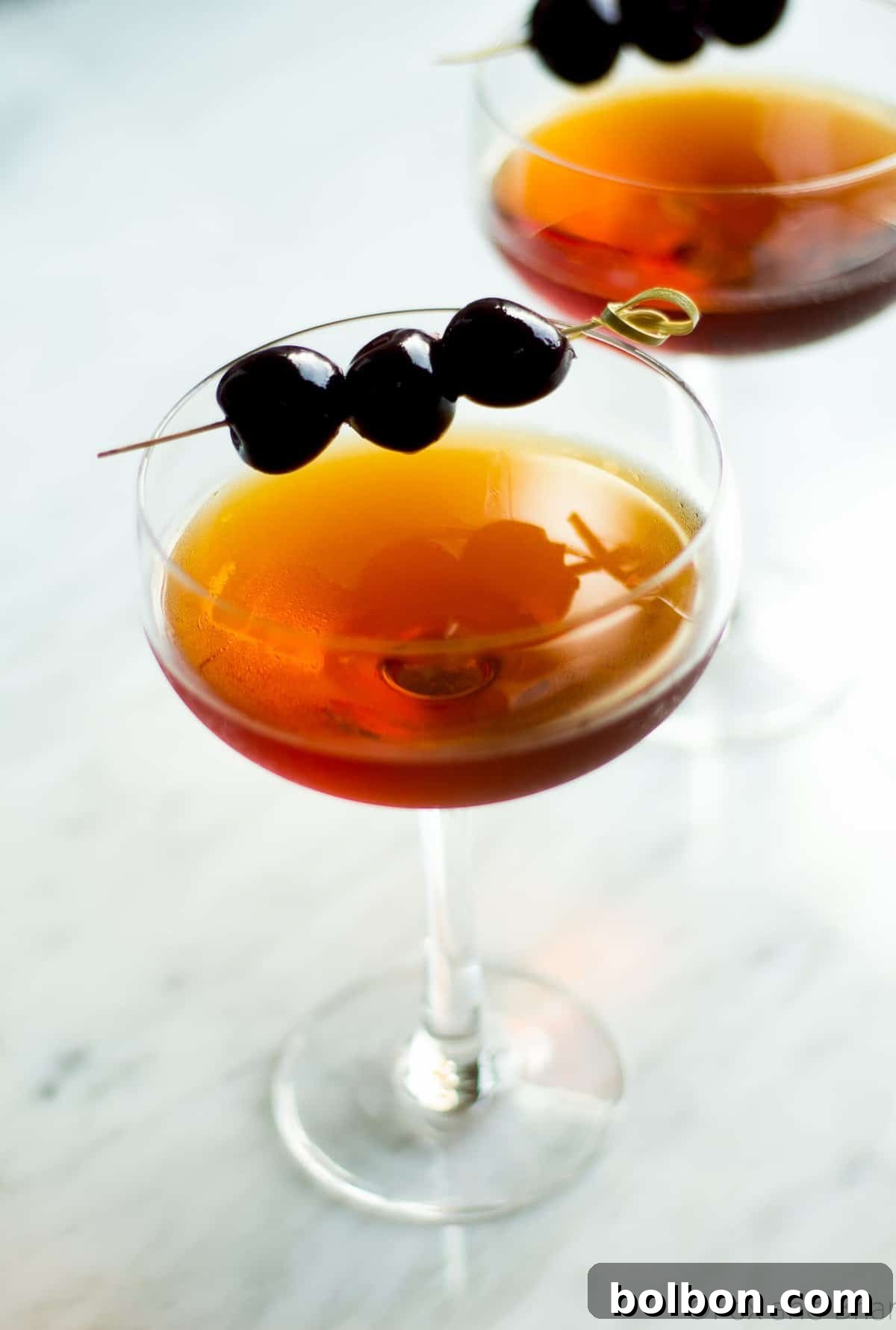 Crafting the Timeless Manhattan 6 A close-up of premium Luxardo Maraschino cherries in their rich syrup, essential for garnishing and enhancing a refined Manhattan.