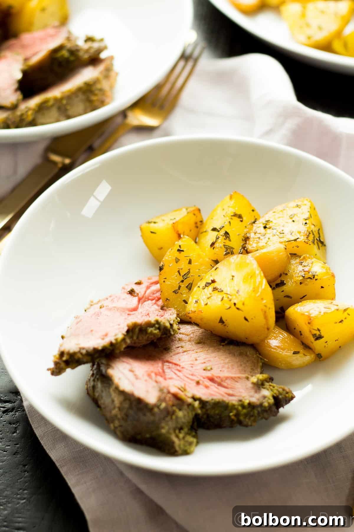 Close-up of the delicious Fresh Herb Boneless Leg of Lamb, perfectly roasted and ready.