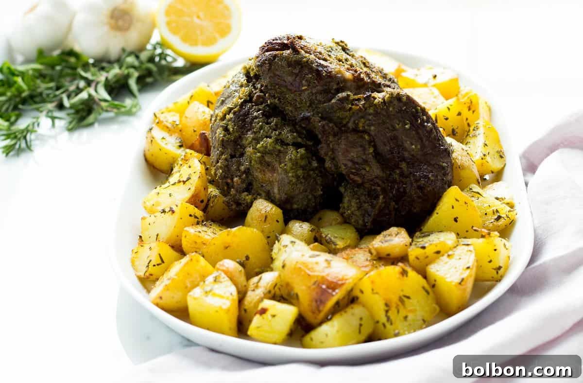 Tender Fresh Herb Boneless Leg of Lamb resting on a cutting board.