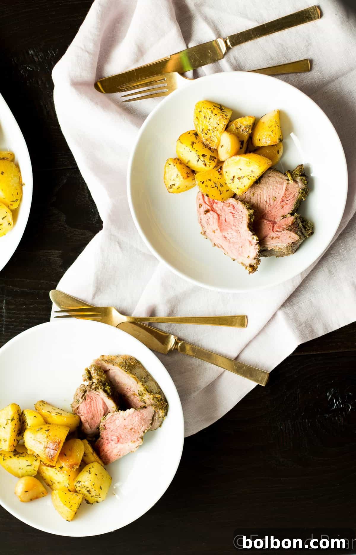 Close-up of a perfectly cooked slice of boneless leg of lamb.