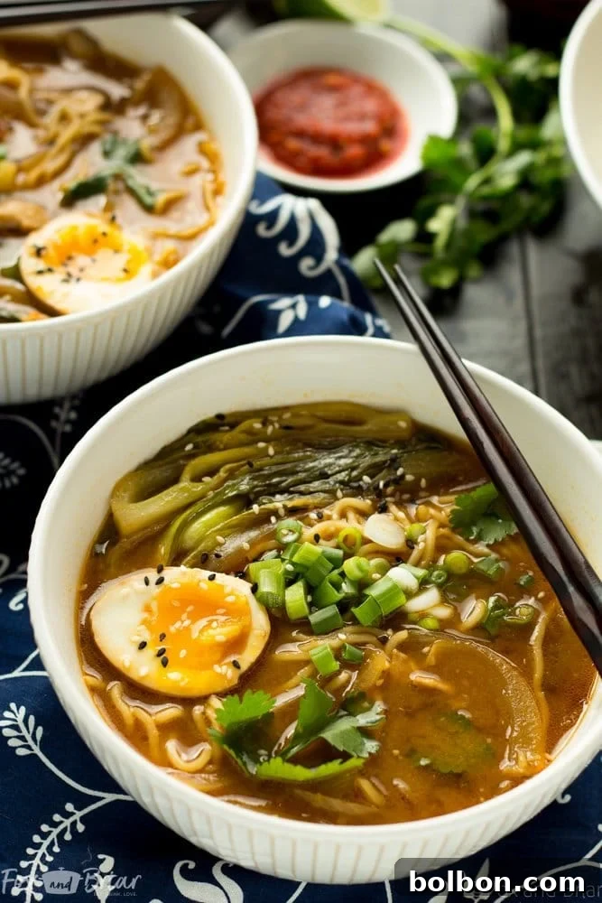 Quick Homemade Chicken Ramen 4 A steamy bowl of homemade chicken ramen with a garnish of green onions.