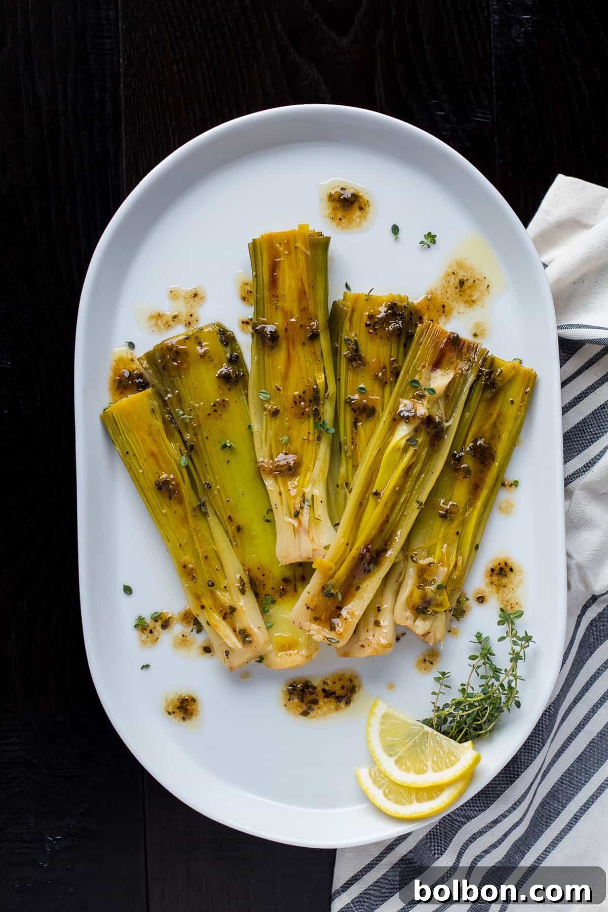 Velvety Braised Leeks 2 Beautifully braised leeks with a golden-brown caramelization, ready to be served as a spring side dish.