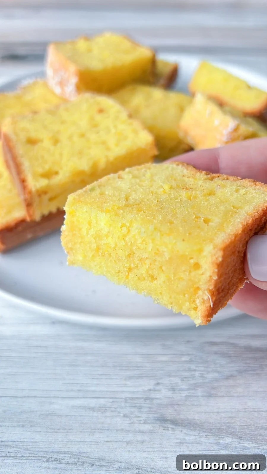 A vibrant and moist slice of Clementine Cake, showcasing its tender crumb and bright citrus zest.