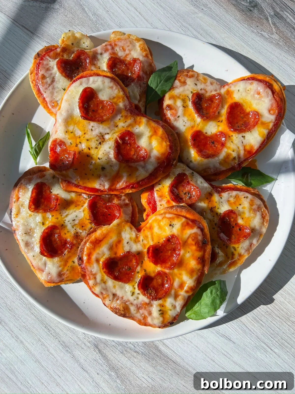 Delicious heart-shaped pizzas with melted cheese and pepperoni, perfect for a special occasion.