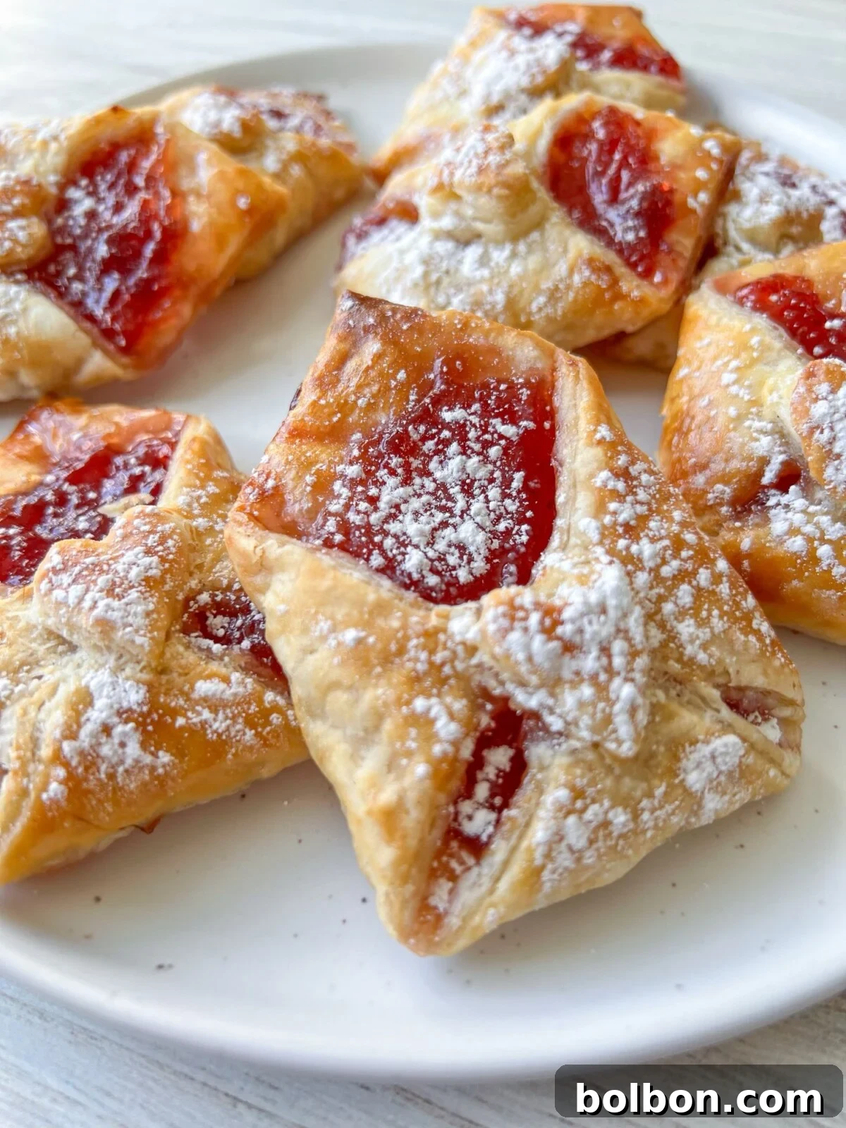 Assortment of Love Letter Pastries with various fillings, dusted with powdered sugar, ready to be served.