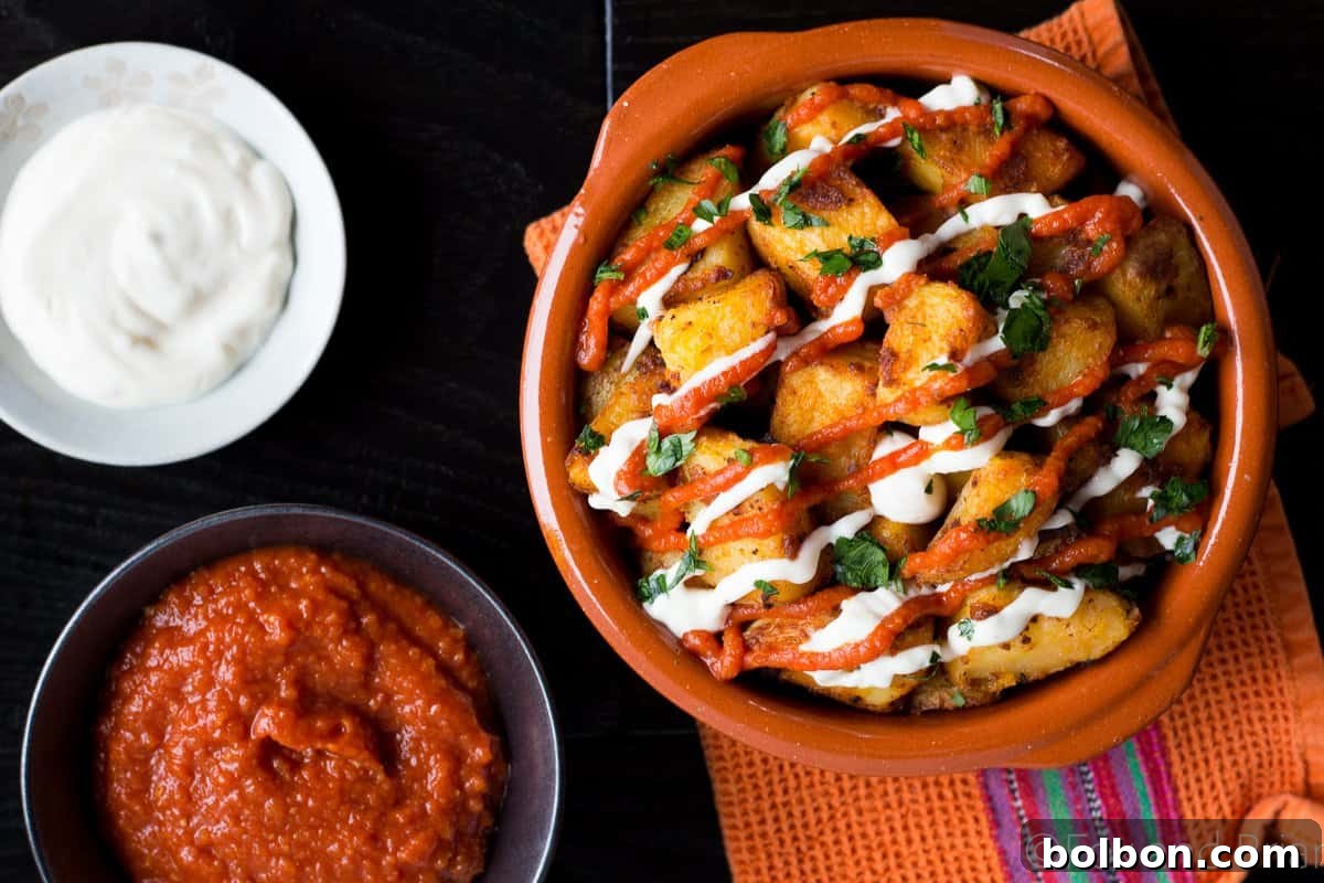 Ultimate Patatas Bravas Guide 7 A close-up shot of creamy garlic aioli in a small white bowl, ready to be drizzled over Patatas Bravas.