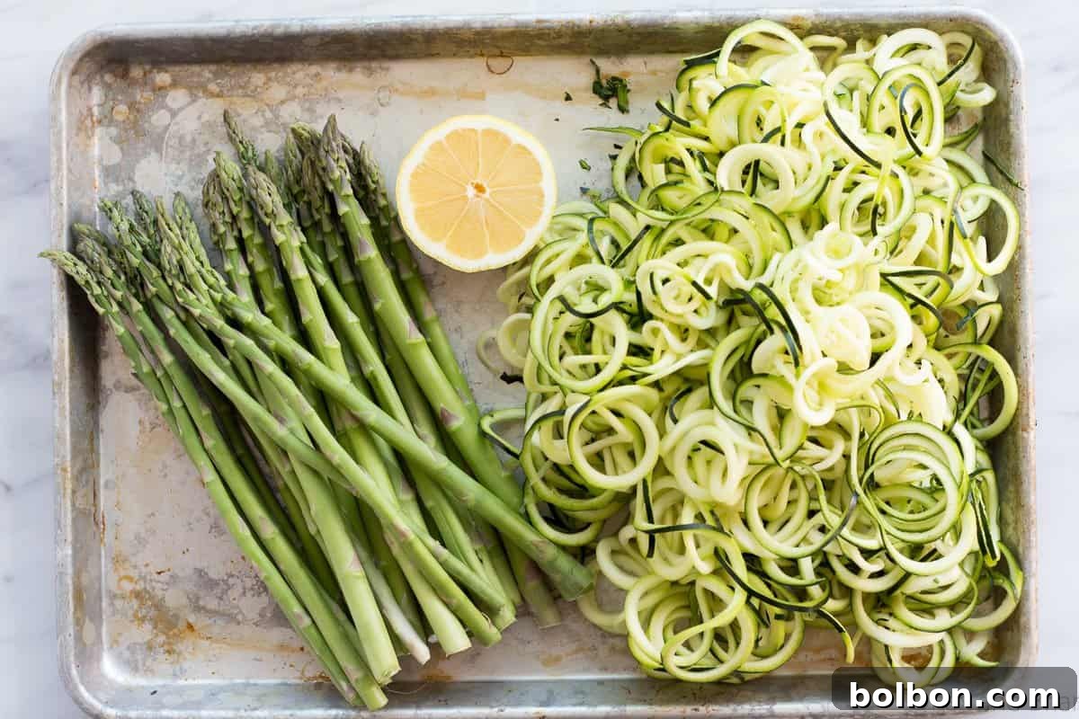 Zoodles (zucchini noodles) quick cooked with asparagus, prosciutto, parmesan cheese, lemon and white wine all topped with a poached egg make a quick and light spring meal.