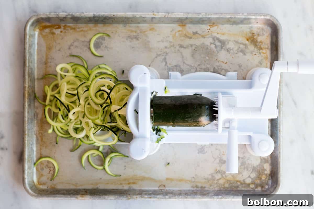 Zoodles (zucchini noodles) quick cooked with asparagus, prosciutto, parmesan cheese, lemon and white wine all topped with a poached egg make a quick and light spring meal.