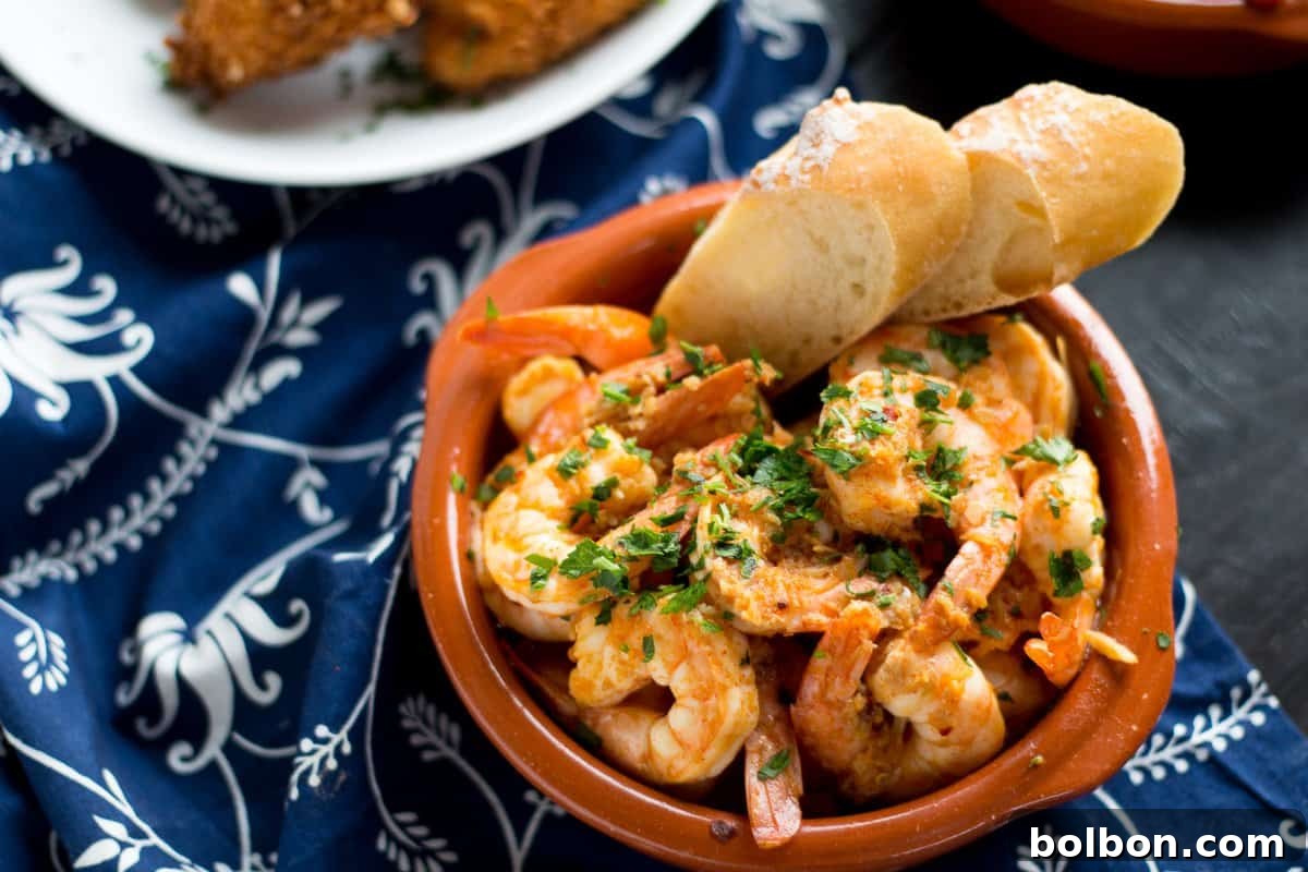 Garlic Shrimp (Gambas al Ajillo) are a classic Spanish tapas dish. Succulent shrimp in a spicy garlicky sauce that you will need to dip your bread into!