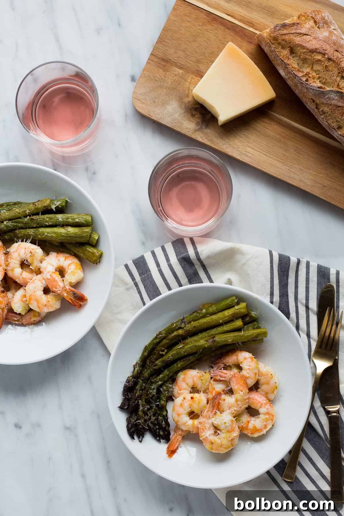 A close-up of the delicious roasted shrimp and asparagus, sprinkled with fresh parmesan, ready to be enjoyed.