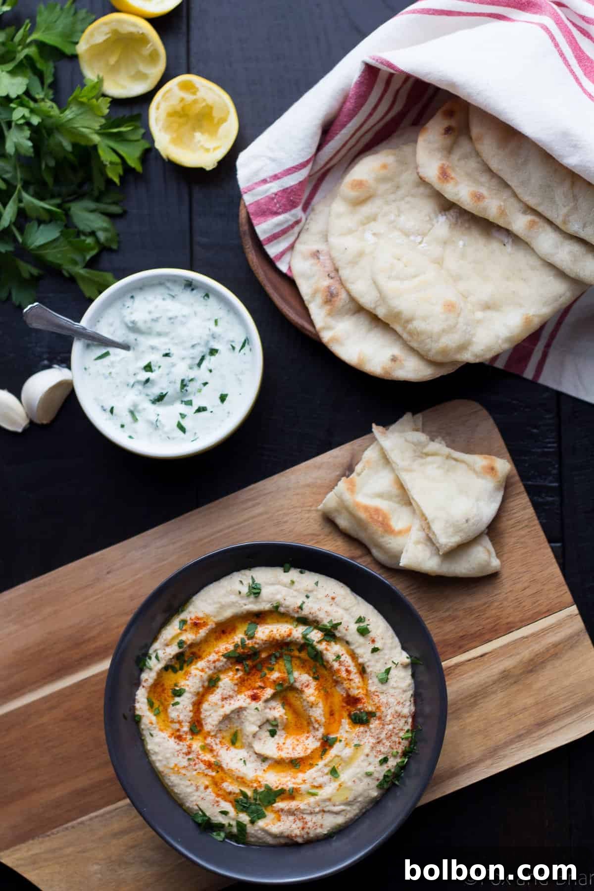 Shaping fresh pita dough into a disc on a floured surface