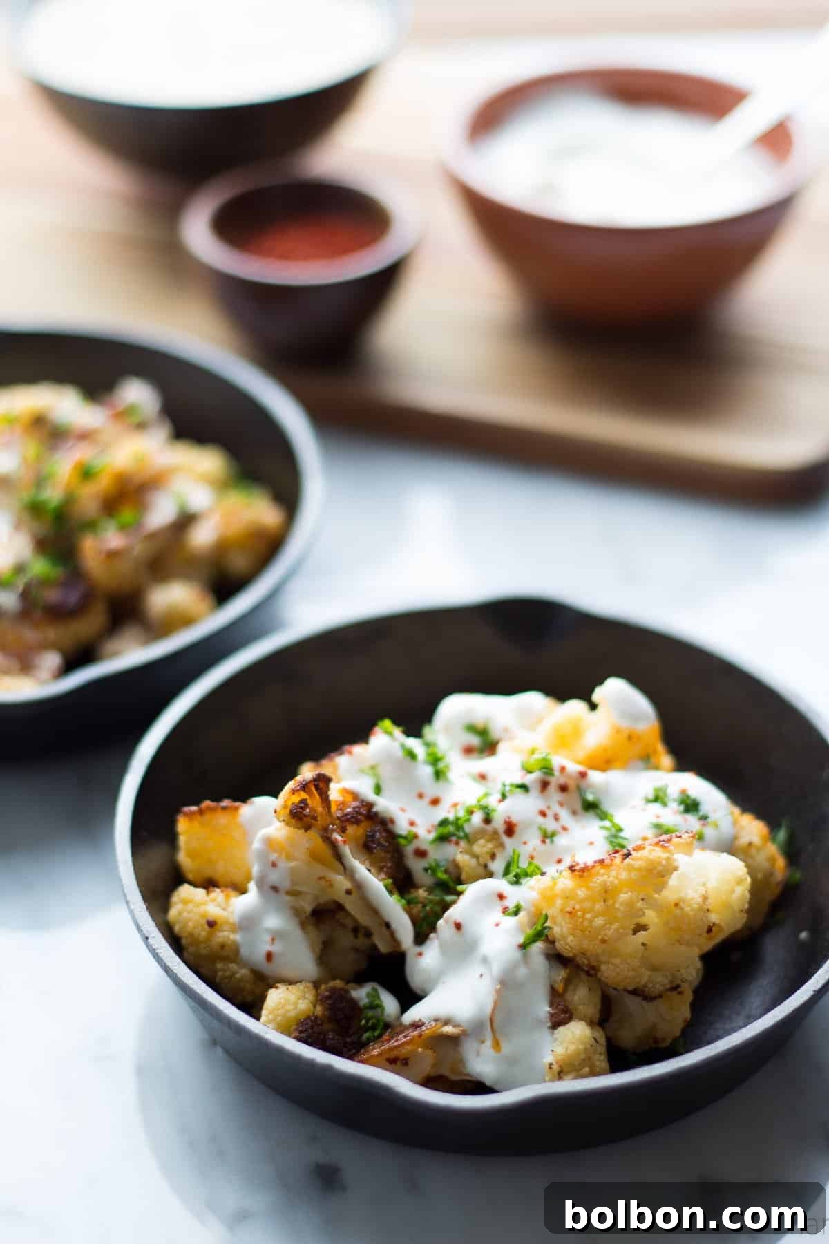 Close-up of golden roasted cauliflower florets, ready to be served, highlighting their inviting texture.